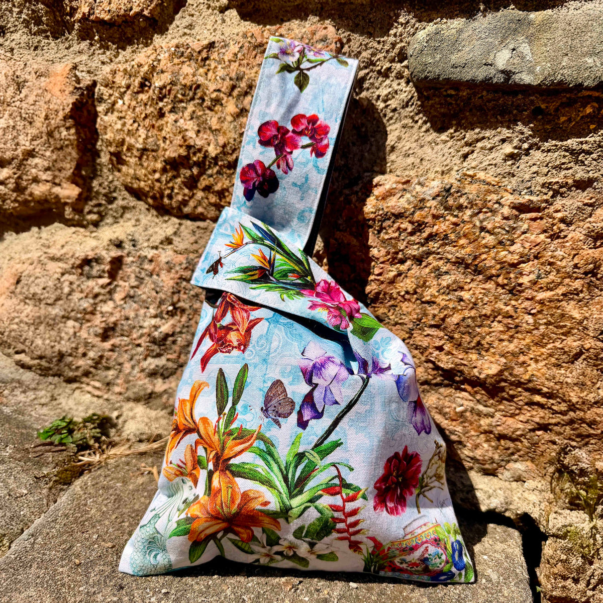 Fine art Japanese knot bag featuring hand-painted Merlion, Vanda Miss Joaquim, and Nyonya teapot