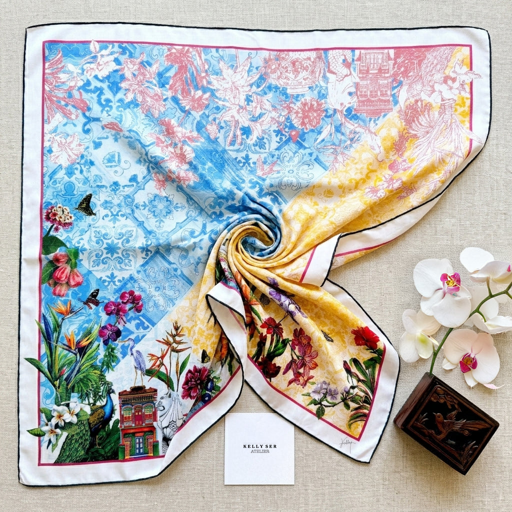 Close-up of luxury silk scarf showing hand-rolled edges and rich oriental blossom print